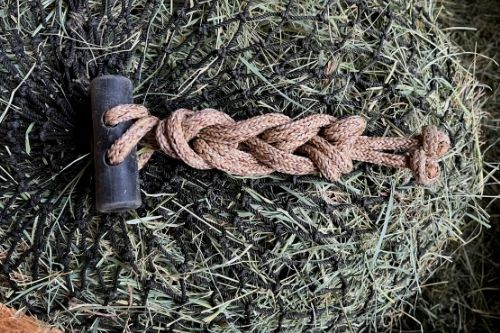 Daisy chain knots used to secure the bale net excess drawstring.